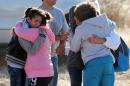 Students are reunited with family following a shooting at Berrendo Middle School, Tuesday, Jan. 14, 2014, in Roswell, N.M. Roswell police said the suspected shooter was arrested at the school, but authorities have not said if there were any injuries. The school has been placed on lockdown. No other details are yet available. (AP Photo/Roswell Daily Record, Mark Wilson)