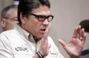 Texas Gov. Rick Perry talks to the media Monday, June 23, 2014, in Weslaco, Texas, after touring the McAllen Border Patrol station. Perry said that the border is not secure, adding, "This is an absolute humanitarian catastrophe waiting to happen." (AP Photo/The Monitor, Gabe Hernandez)