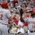 Cincinnati Reds' Jay Bruce (32) is greeted by teammate Derrick Robinson (15) after hitting a solo home run off Pittsburgh Pirates starting pitcher Wandy Rodriguez during the fourth inning of a baseball game in Pittsburgh on Friday, May 31, 2013. (AP Photo/Gene J. Puskar)