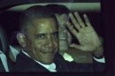 U.S. President Barack Obama waves from his car after landing at the airport in Los Cabos