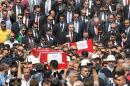 Turkey's President Tayyip Erdogan (C, R) and Prime Minister Ahmet Davutoglu (C, L) attend the funeral in Ankara on September 9, 2015 of police killed in a bombing by PKK militants