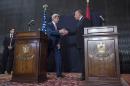 U.S. Secretary of State John Kerry, left, shakes hands with Egyptian Foreign Minister Sameh Shukri at the end of a joint press conference in Cairo, Egypt, on Saturday, Sept. 13, 2014. Kerry described Egypt as an 