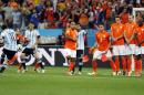Argentina's Lionel Messi, left, shoots a free-kick past the Dutch defense during the World Cup semifinal soccer match between the Netherlands and Argentina at the Itaquerao Stadium in Sao Paulo, Brazil, Wednesday, July 9, 2014. (AP Photo/Frank Augstein)