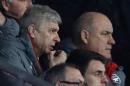 Arsenal's French manager Arsene Wenger (L) gives instructions to the dugout from the director's box during their English FA Cup match against Southampton on January 28, 2017
