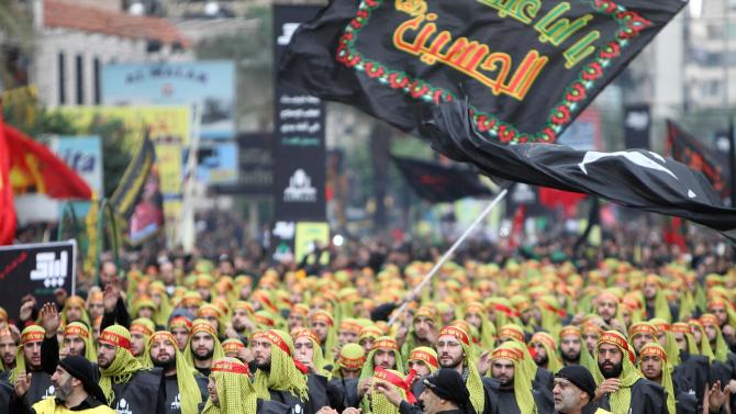 Supporters of Lebanon&#39;s Hezbollah movement take part in a parade on November 4, 2014 in Beirut&#39;s southern suburbs, where Mohammad Shawraba lived