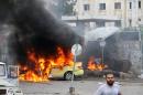 A car in flames at the scene of bombings in the Syrian city of Tartus, northwest of Damascus, on May 23, 2016