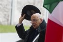 Italian President Giorgio Napolitano lifts his hat as he meets with German Chancellor Angela Merkel (not pictured) for talks at the Chancellery in Berlin