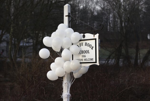 Balloons hang from the Sandy Hook School sign in Sandy Hook, Connecticut December 15, 2012. Residents of the small Connecticut community of Newtown were reeling on Saturday from one of the worst mass shootings in U.S. history, as police sought answers about what drove a 20-year-old gunman to slaughter 20 children at an elementary school.  
REUTERS/Shannon Stapleton (UNITED STATES - Tags: CRIME LAW EDUCATION)