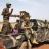 Malian soldiers ride in a Malian army pickup truck in Diabaly