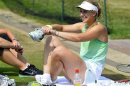 Sabine Lisicki of Germany sits on the ground during a training session on a practise court at the Wimbledon Tennis Championships, in London