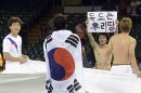 South Korea's Park Jong-woo holds a sign reading "Dokdo is our territory" after his team's 2-0 victory over Japan in their men's bronze medal soccer match at the London 2012 Olympic Games at Millennium Stadium in Cardiff