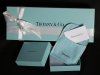 This Nov. 27, 2012, photo shows Tiffany & Co. gift boxes displayed in Boston. Tiffany & Co. said Thursday, Nov. 29, 2012, third-quarter net income fell 30 percent, stung by a higher-than-expected tax rate, ongoing economic weakness and high precious metal and diamond costs. (AP Photo/Elise Amendola)