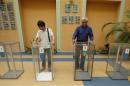 Election commission officials install ballot boxes at a poling station in Kiev