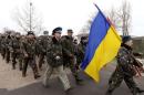 Ukrainian servicemen march away, after negotiations with Russian troops at the Belbek Sevastopol International Airport in the Crimea region