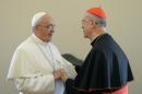 This handout picture released on October 15, 2013 by the Vatican press office shows Pope Francis speaking with Vatican Secretary of State Cardinal Tarcisio Bertone (R) during a farewell ceremony at the Vatican