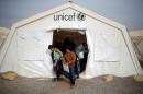 Displaced Iraqi boys leave a tent school set by UNICEF at Hassan Sham camp, east of Mosul