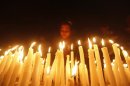 A girl lights candles during a candlelight vigil for a gang rape victim who was assaulted in New Delhi, in Kolkata