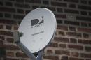 A Direct TV dish is seen outside a home in the Queens borough of New York