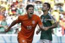 Netherlands' Klaas-Jan Huntelaar celebrates after scoring his side's second goal during the World Cup round of 16 soccer match between the Netherlands and Mexico at the Arena Castelao in Fortaleza, Brazil, Sunday, June 29, 2014. The Netherlands won the match 2-1. (AP Photo/Natacha Pisarenko)