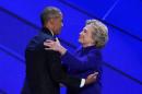 US Democratic presidential nominee Hillary Clinton embraces President Barack Obama on stage during the Democratic National Convention at the Wells Fargo Center in Philadelphia, Pennsylvania on July 27, 2016