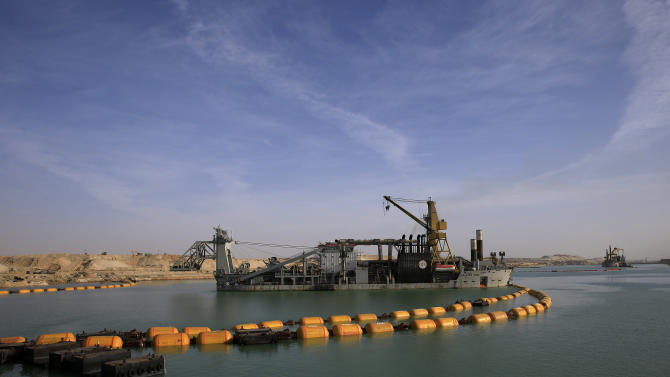 Dredger float on a new section of the Suez canal during a media tour in Ismailia, Egypt, Wednesday, Feb. 4, 2015. The head of the Suez Canal Authority, Mohab Mameesh, says work is on schedule and that so far, 86 percent of the dry digging and 21 percent of the dredging has been completed, with the new section expected to be completed in August 2015.  (AP Photo/Hassan Ammar)