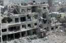 This image taken from video obtained from the Shaam News Network, which has been authenticated based on its contents and other AP reporting, shows damaged buildings due to heavy shelling in the Damascus suburb of Daraya, Syria, on Wednesday, April 3, 2013. (AP Photo/Shaam News Network via AP video)