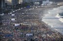 Pilgrims and residents gather on Copacabana beach before the arrival of Pope Francis for World Youth Day in Rio de Janeiro, Brazil, Saturday, July 27, 2013. Francis will preside over an evening vigil service on Copacabana beach that is expected to draw more than 1 million young people. (AP Photo/Felipe Dana)