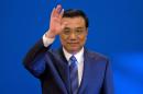 FILE - In this March 13, 2014 file photo, Chinese Premier Li Keqiang waves as he arrives for a press conference after the closing ceremony of the National People's Congress held in Beijing's Great Hall of the People, China. Li set off for a four-country tour of Africa on Sunday, May 4, 2014, acknowledging "growing pains" in China-Africa relations amid labor conflicts and other problems stemming from Chinese investment.(AP Photo/Ng Han Guan, File)