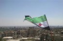 An opposition flag is seen over neighborhood Ruknuddin in Damascus