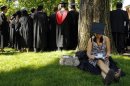Graduating student Jennifer Lim sits in the shade at Harvard University in Cambridge