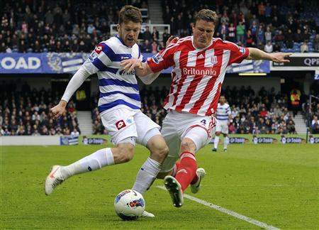 QPR's Mackie challenges Stoke City's Huth during their English Premier League soccer match in London