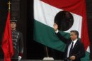 Hungarian Prime Minister Viktor Orban waves after his speech in front of the Hungarian Parliament Building in Budapest