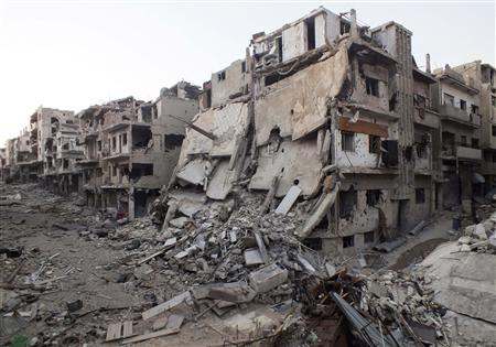 A general view shows damaged buildings on a deserted street in the besieged area of Homs