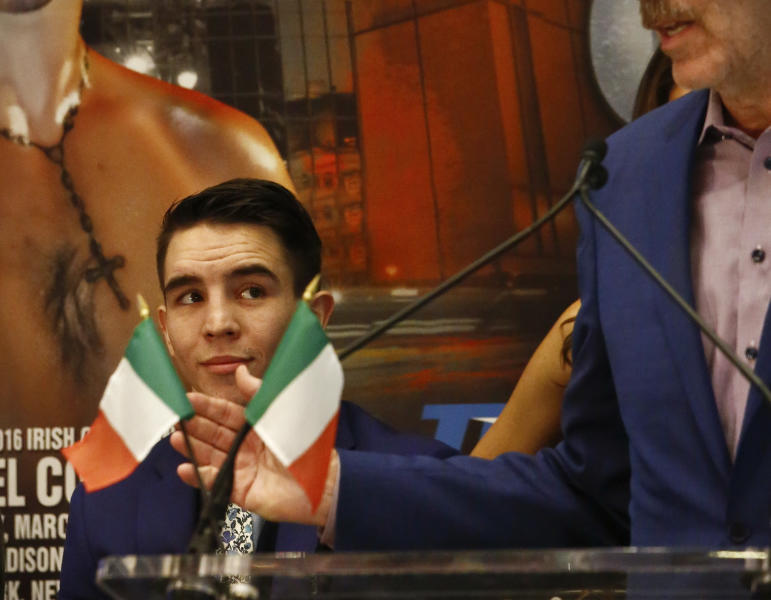Michael Conlan, left, of Belfast, Northern Ireland, who boxed for Ireland at the London Olympics, listens during his introduction at a press conference, Wednesday, Jan. 18, 2017, at Madison Square Garden in New York. Conlan makes his pro debut in New York on St. Patrick's Day, Friday March 17, in a junior featherweight bout against Denver's Tim Ibarra. (AP Photo/Bebeto Matthews)