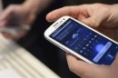 A man uses Samsung Electronics' new Samsung Galaxy SIII smartphone during its launch in London