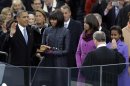 President Barack Obama receives the oath of office from Chief Justice John Roberts at the ceremonial swearing-in at the U.S. Capitol during the 57th Presidential Inauguration in Washington, Monday, Jan. 21, 2013. First Lady Michelle Obama holds the bible as daughters Malia and Sasha watch. (AP Photo/Carolyn Kaster)