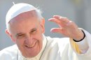 Pope Francis waves to the crowd in St Peter's square at the Vatican on September 18, 2013