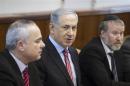 Israel's Prime Minister Netanyahu sits next to Cabinet Secretary Mandelblit and Intelligence Minister Steinitz during a weekly cabinet meeting in Jerusalem