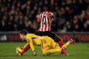 West Ham United goalkeeper Adrian battles for the ball with Southampton's Sadio Mane, rear, before being sent off during the English Premier League soccer match at St Mary's, Southampton, England, Wednesday Feb. 11, 2015. (AP Photo/PA, John Walton) UNITED KINGDOM OUT