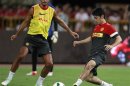 Manchester United's Kagawa and Ferdinand fight for the ball during a training session at the Shanghai Stadium
