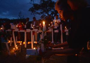 People hold candles, roses and wooden crosses in Nairobi&nbsp;&hellip;