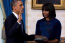 U.S. President Obama takes the oath of office as frst lady Michelle Obama holds a bible during the official swearing-in ceremony at the White House in Washington