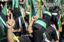 Masked Hamas members take part in a rally in support of the armed Palestinian factions, in Rafah in the southern Gaza Strip