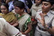 Maya Kodnani (C), a state assembly lawmaker and former Gujarat state minister, is escorted to prison by police after a court hearing in the western Indian city of Ahmedabad August 29, 2012. REUTERS/Amit Dave