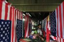 A girl hangs the newly made U.S flags at a shop in Yangon.