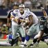 Cowboys quarterback Tony Romo scrambles as Philadelphia Eagles defensive tackle Cullen Jenkins is unable to make the tackle in Arlington, Texas