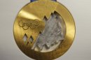 The gold medal is displayed for journalists during a presentation of Sochi 2014 Olympic medals at the SportAccord International Convention in St. Petersburg, Russia, Thursday, May 30, 2013. (AP Photo/Dmitry Lovetsky)