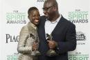 Actress Nyong'o and director McQueen pose with their awards for "12 Years a Slave" backstage at the 2014 Film Independent Spirit Awards in Santa Monica