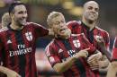 AC Milan's Keisuke Honda, center, celebrates with his teammates Adil Rami, left, and Alex, after scoring during the Serie A soccer match between AC Milan and Chievo at the San Siro stadium in Milan, Italy, Saturday, Oct. 4, 2014. (AP Photo/Antonio Calanni)