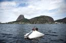 Hamilton Cunha Filho gestures from his "floating house" -- a raft he made with things found on the streets -- in Guanabara Bay in Rio de Janeiro, Brazil, on March 20, 2015